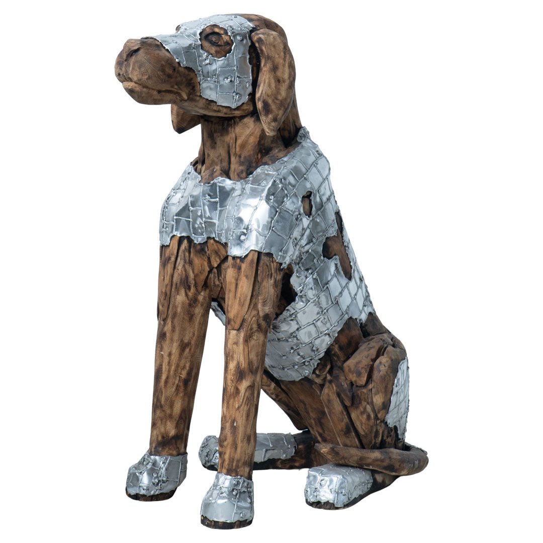 A decorative metal dog sculpture shown against a plain white background. The dog is seated and crafted from weathered brown wood and silver-toned metal plates, with a distressed, patchwork finish.