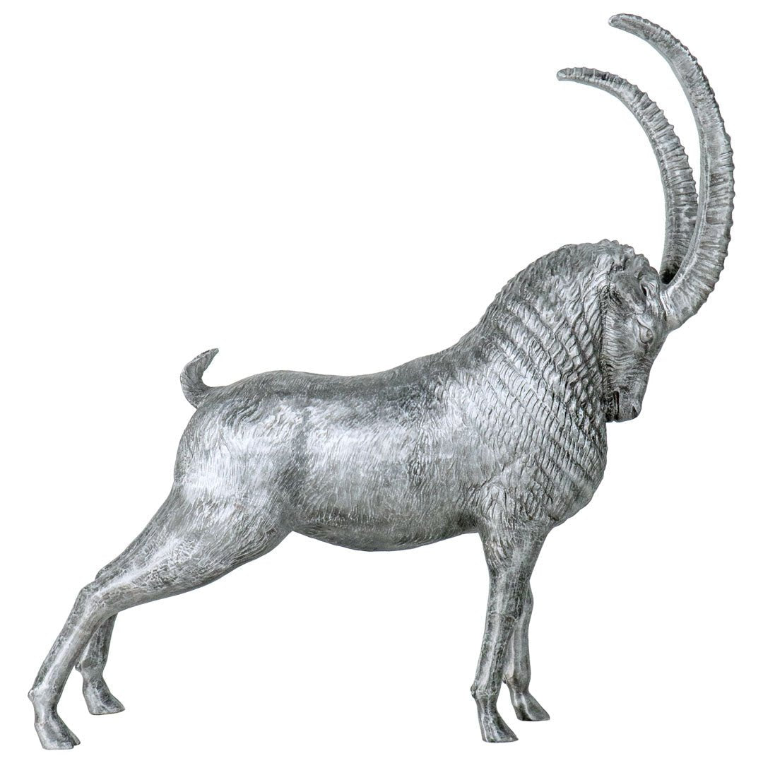 A metallic silver ram figurine with long curved horns, shown in profile against a plain white background.