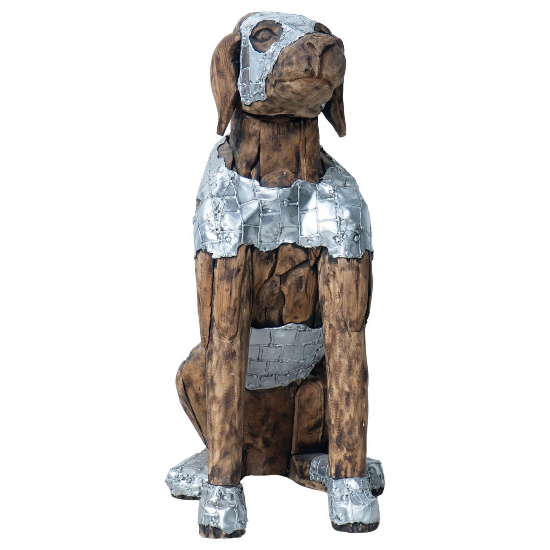 A decorative sculpture of a sitting dog made from brown wood with metallic silver painted armor-like details on the head, chest, and paws, shown against a plain white background.