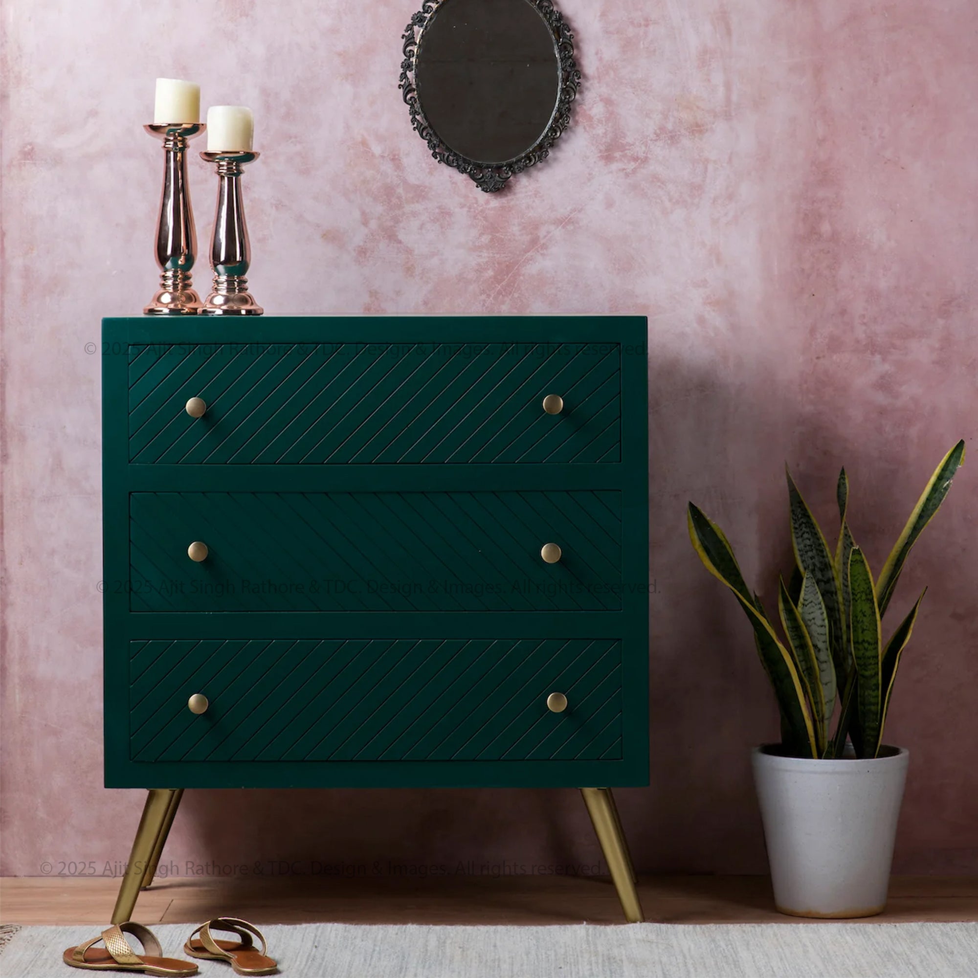 A deep emerald green mid-century modern chest of drawers with brass-finished handles and legs