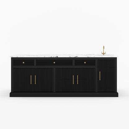 Black kitchen island with white countertop and gold fixtures on a white background