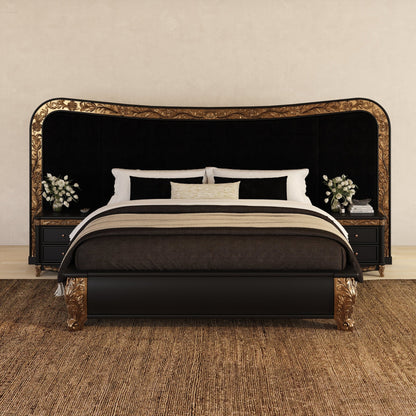 An ornate black and gold bed frame with a tall arched headboard and matching footboard, styled with dark bedding, white pillows, and matching nightstands on a textured brown rug against a beige wall.