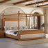 A four-poster canopy bed with a warm medium-brown wood frame and tufted cream upholstered headboard and footboard, styled in a rustic bedroom with stone arches, wooden ceiling beams, and a chandelier.