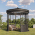 Black metal gazebo with outdoor furniture on a grassy area with trees and blue sky in the background